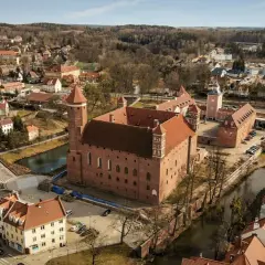 Lidzbark Warmiński atrakcje: imponujący zamek biskupów warmińskich, otoczony fosą i malowniczym miasteczkiem.