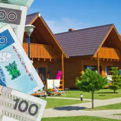 Zniżki na booking! Polskie banknoty przed domkami letniskowymi.